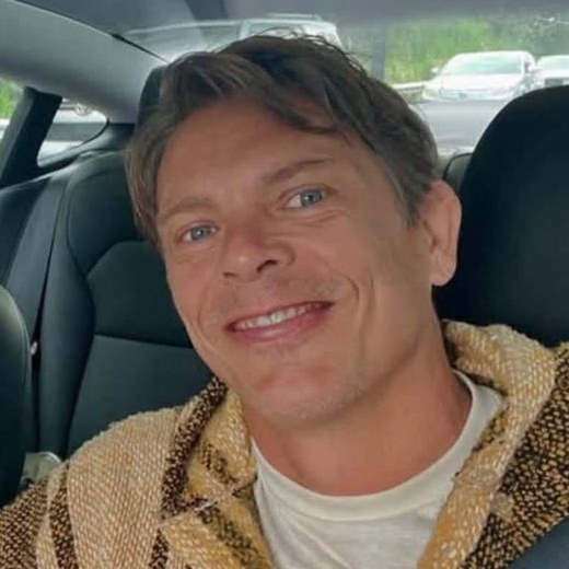 Tam Hunt, smiling, in a woven jacket