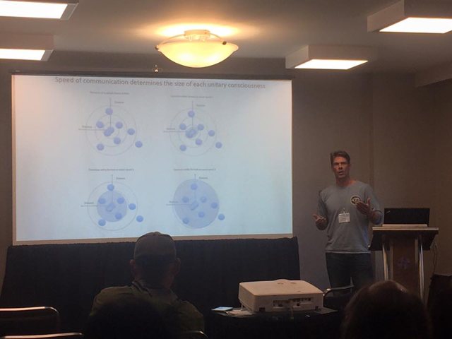 Tam presenting General Resonance Theory to a conference audience